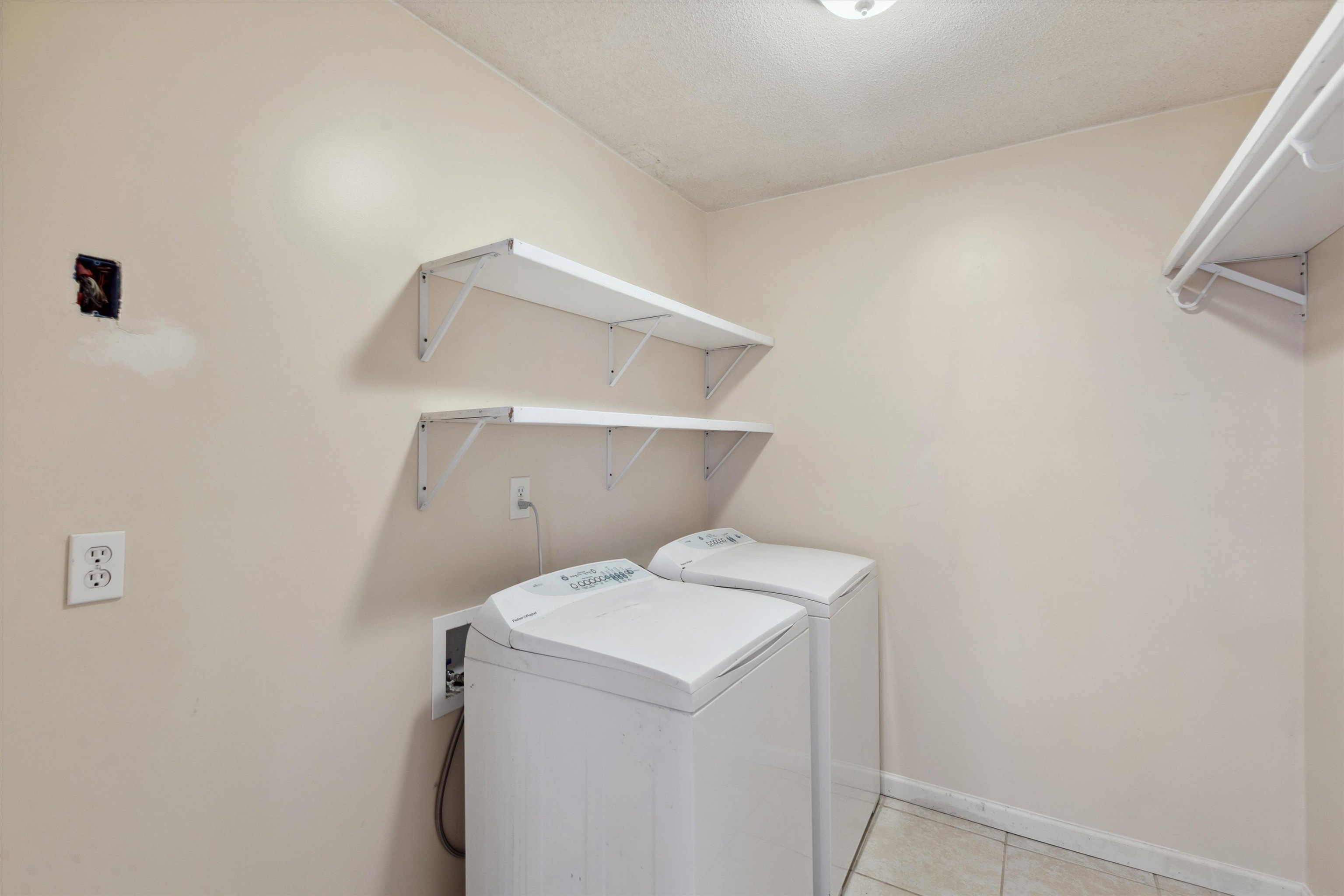 5747 Bartlett Woods Drive Bartlett, TN 38134 - Photo 18 of 28 Washroom featuring independent washer and dryer, laundry area, light tile patterned flooring, and baseboards