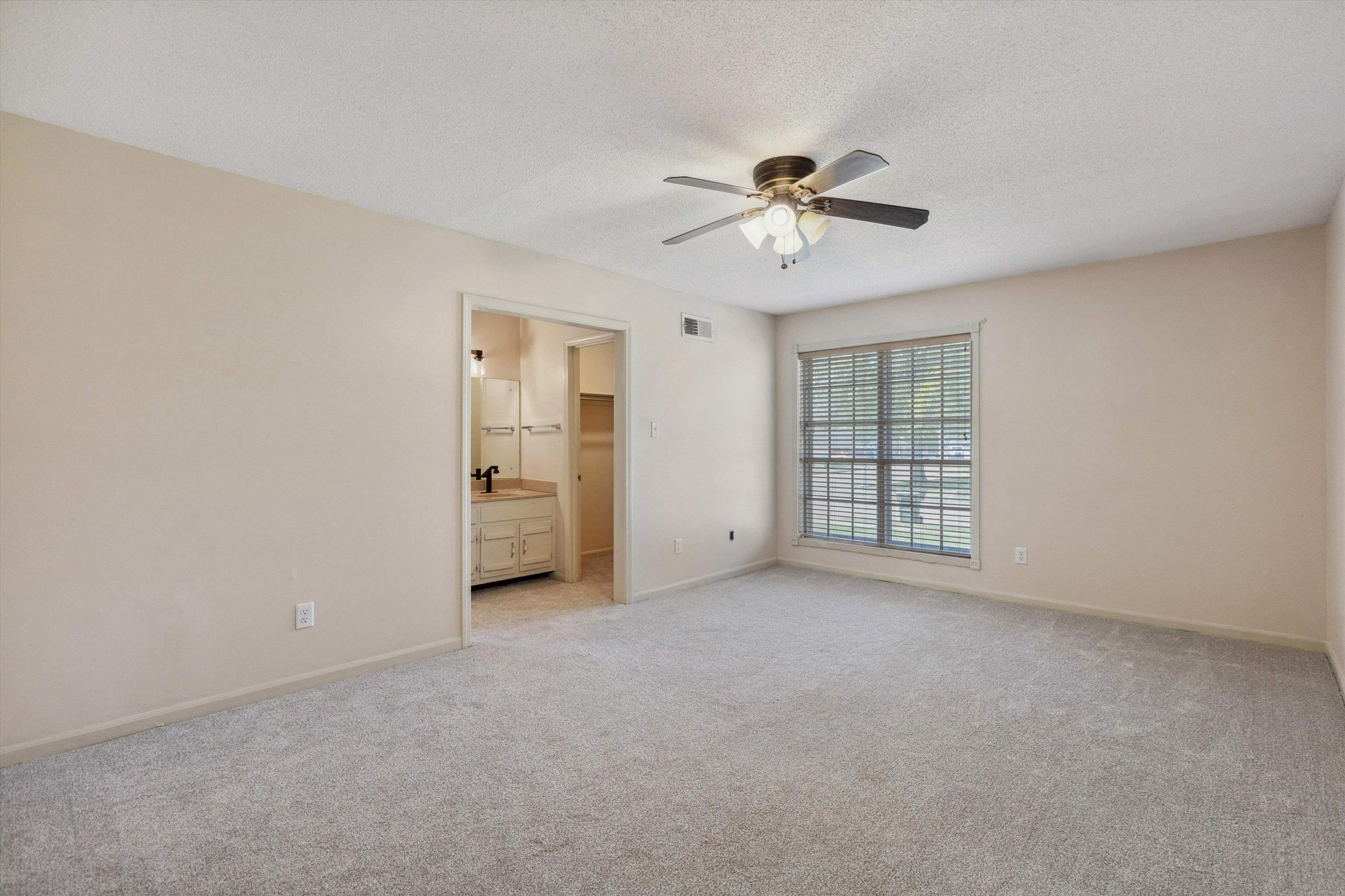 5747 Bartlett Woods Drive Bartlett, TN 38134 - Photo 19 of 28 Interior space featuring visible vents, baseboards, a sink, a ceiling fan, and light colored carpet