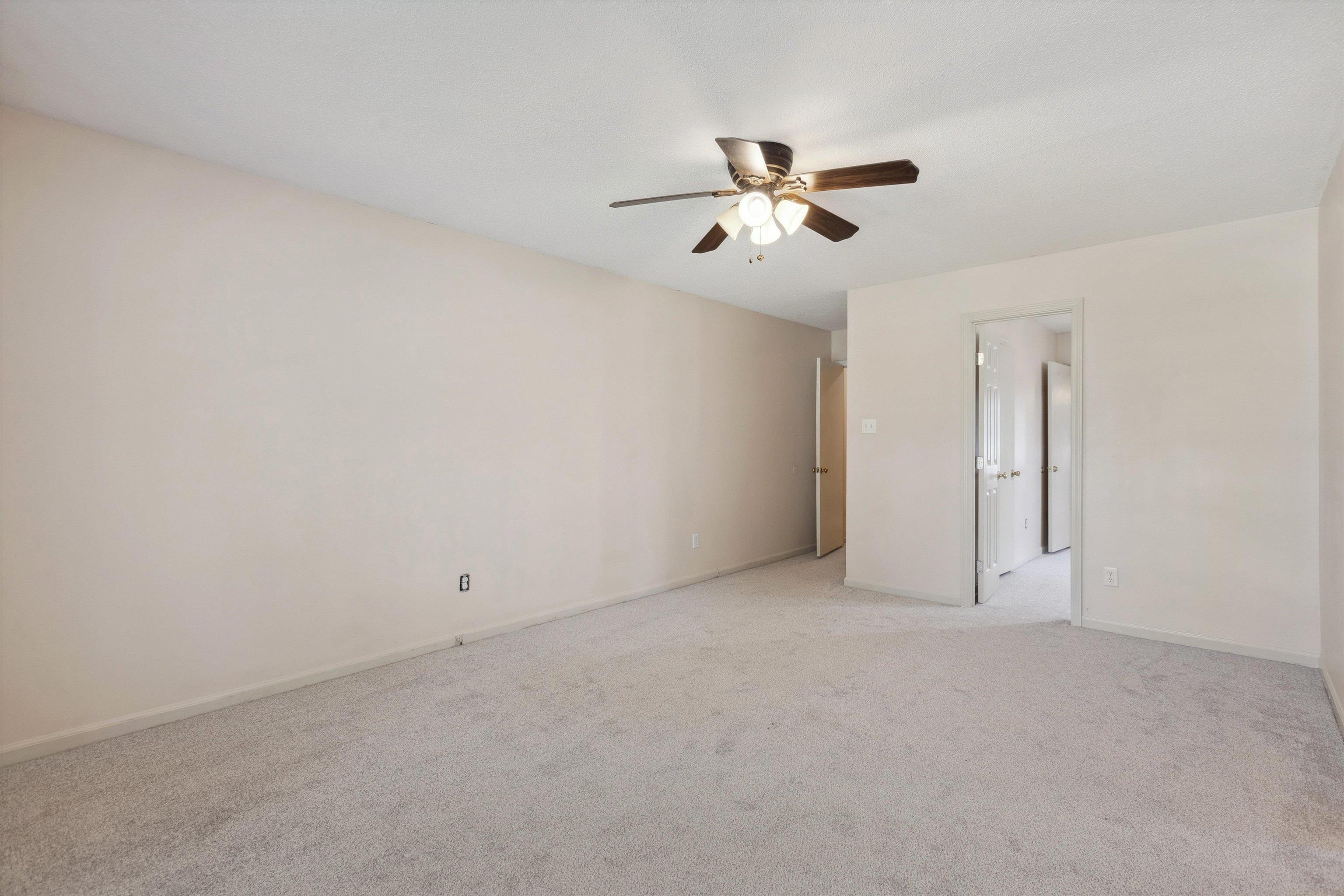 5747 Bartlett Woods Drive Bartlett, TN 38134 - Photo 20 of 28 Spare room with light colored carpet, ceiling fan, and baseboards