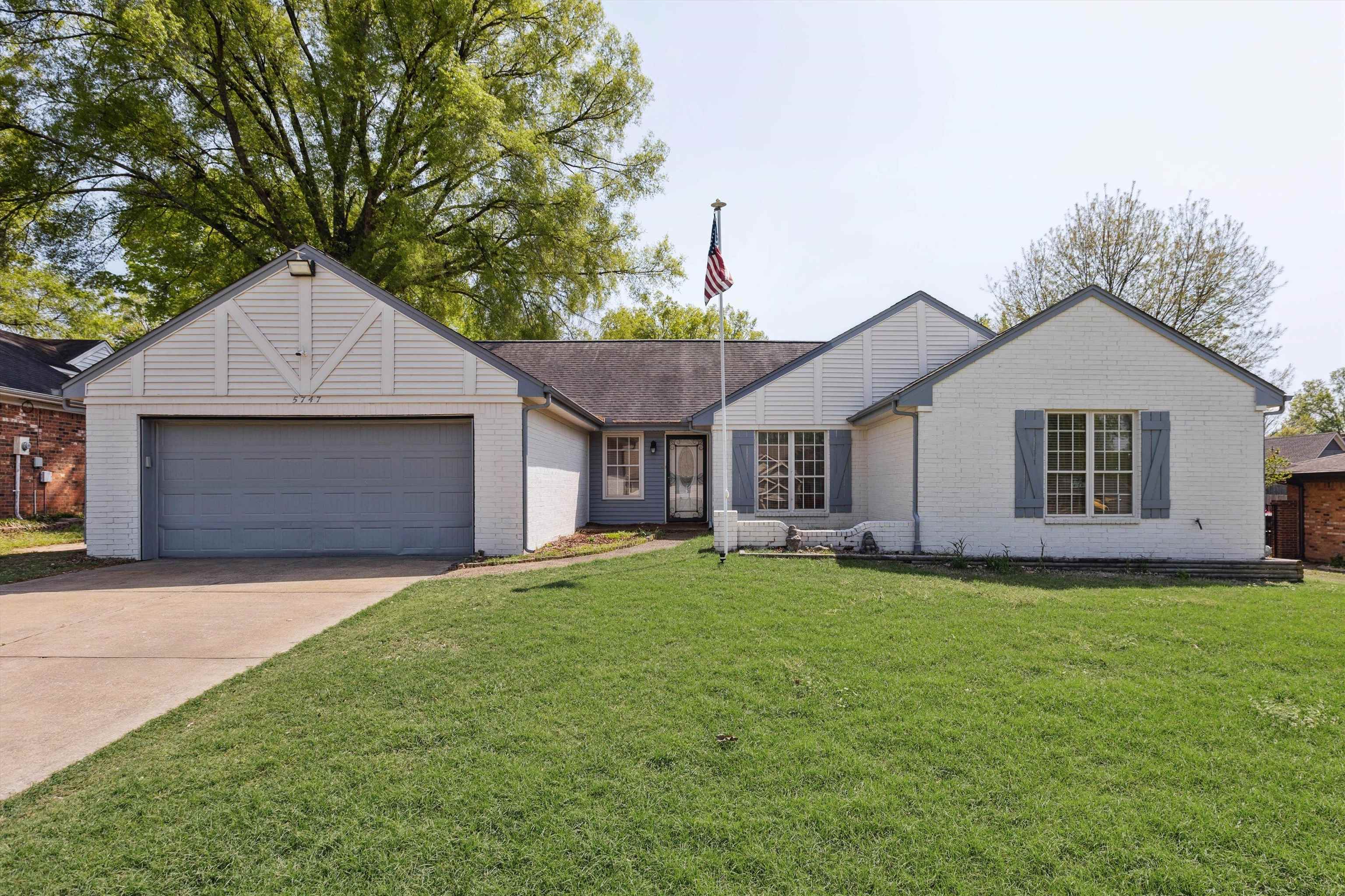 5747 Bartlett Woods Drive Bartlett, TN 38134 - Photo 2 of 28 Single story home featuring a garage, a front yard, concrete driveway, and brick siding