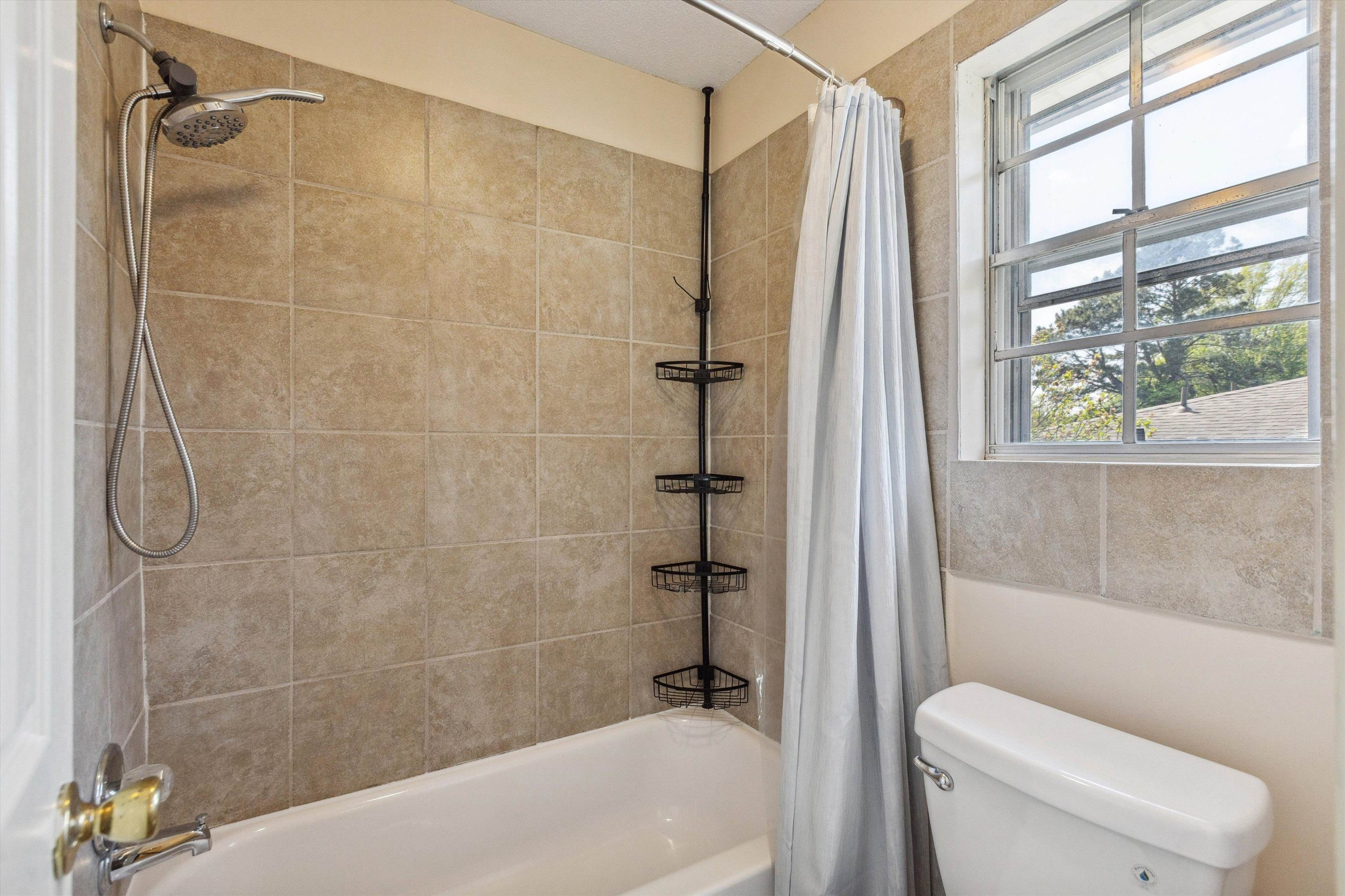 5747 Bartlett Woods Drive Bartlett, TN 38134 - Photo 22 of 28 Full bathroom featuring toilet and shower / bathtub combination with curtain