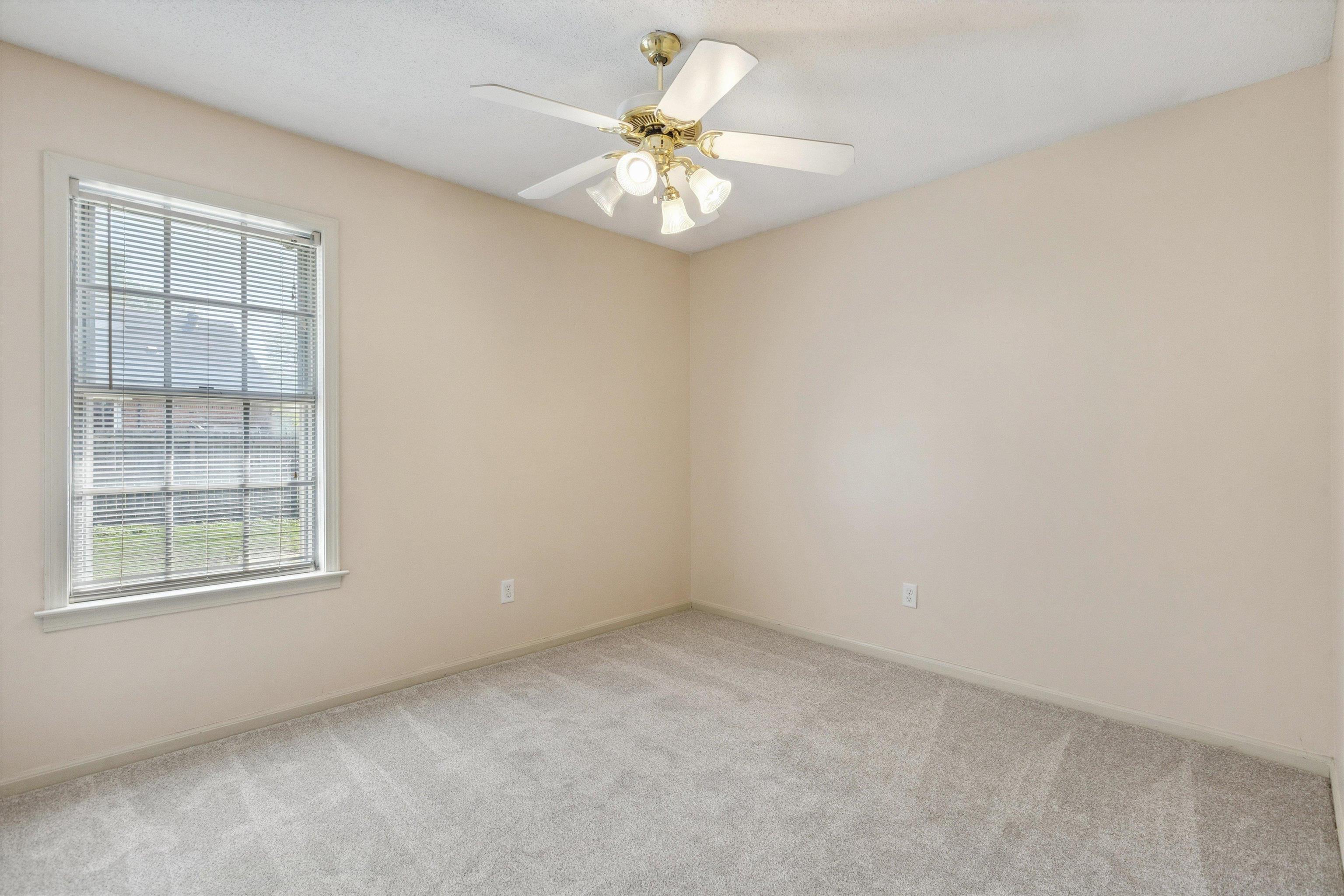 5747 Bartlett Woods Drive Bartlett, TN 38134 - Photo 24 of 28 Spare room featuring baseboards, ceiling fan, and carpet