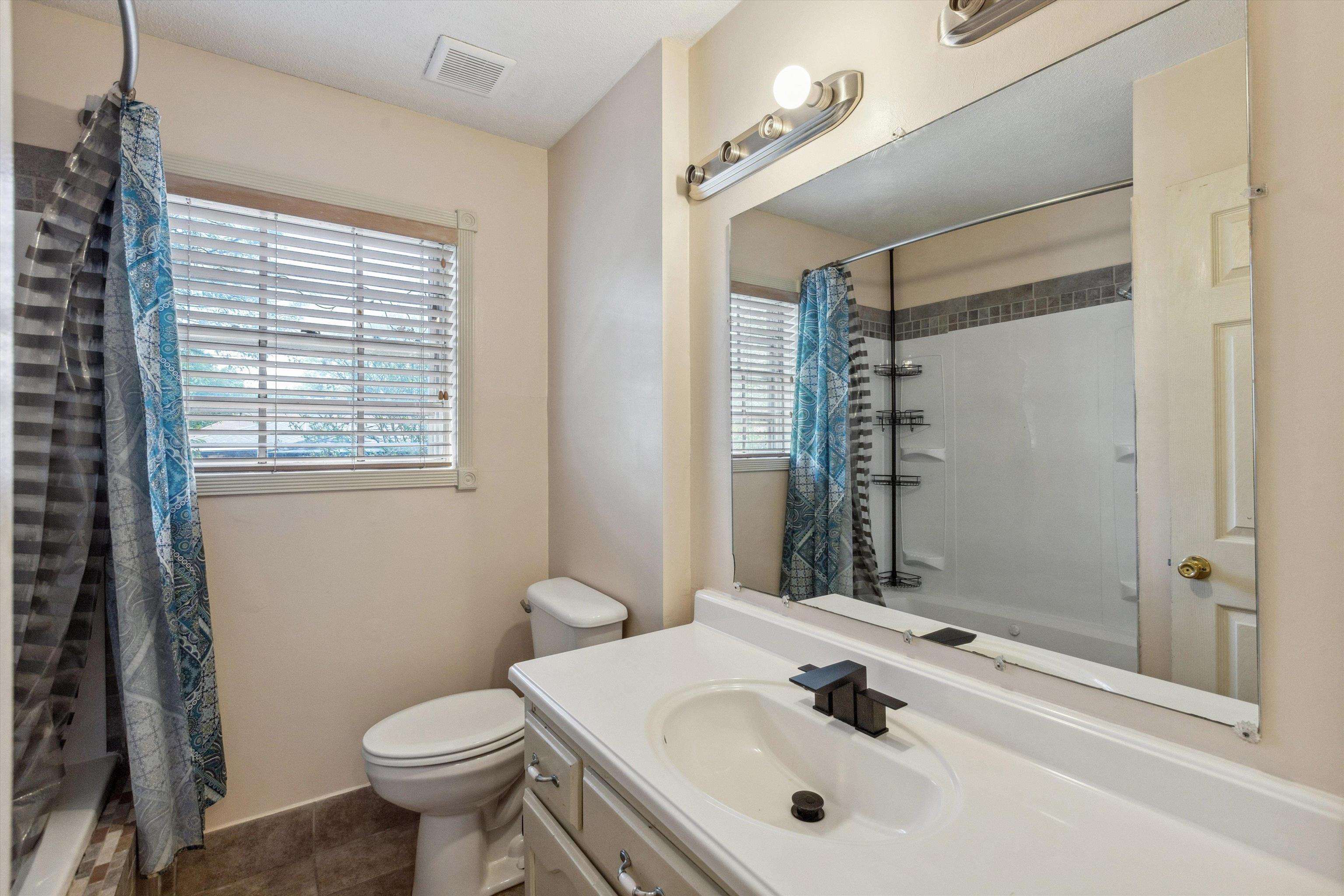 5747 Bartlett Woods Drive Bartlett, TN 38134 - Photo 25 of 28 Bathroom featuring shower / bath combo, visible vents, toilet, and vanity