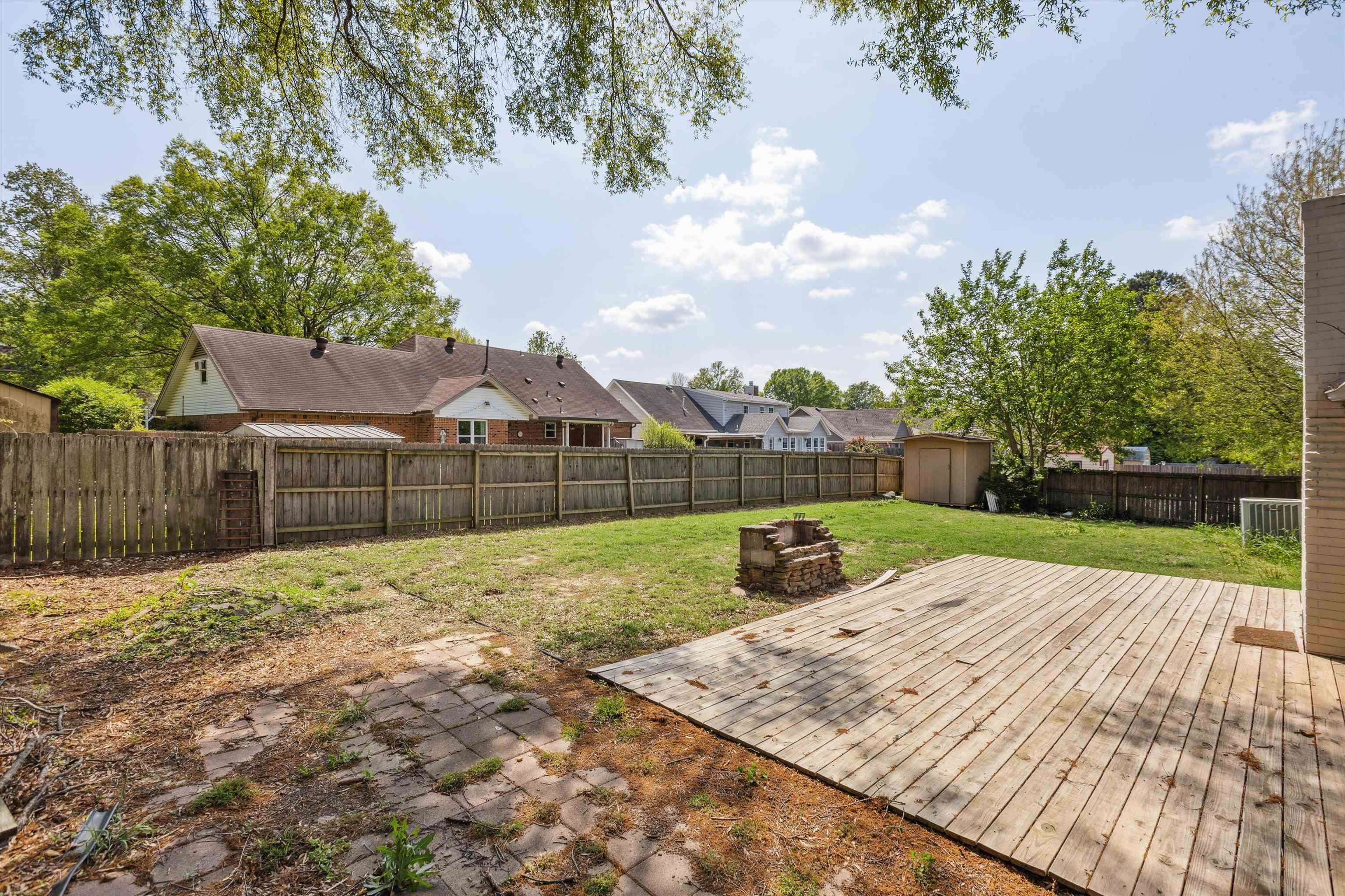 5747 Bartlett Woods Drive Bartlett, TN 38134 - Photo 27 of 28 View of yard featuring an outbuilding, a fenced backyard, a deck, and a shed