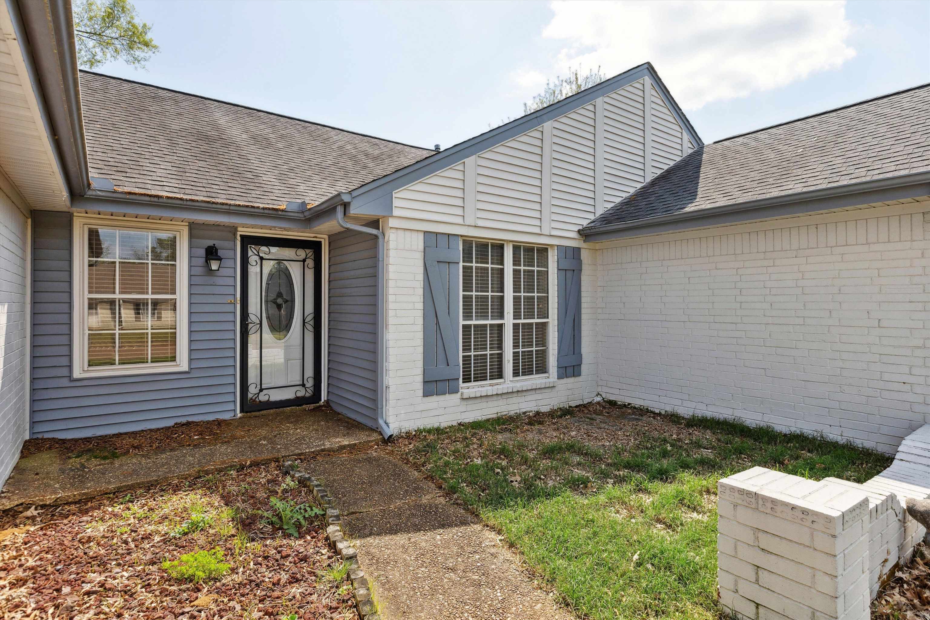 5747 Bartlett Woods Drive Bartlett, TN 38134 - Photo 5 of 28 Doorway to property with a shingled roof and brick siding