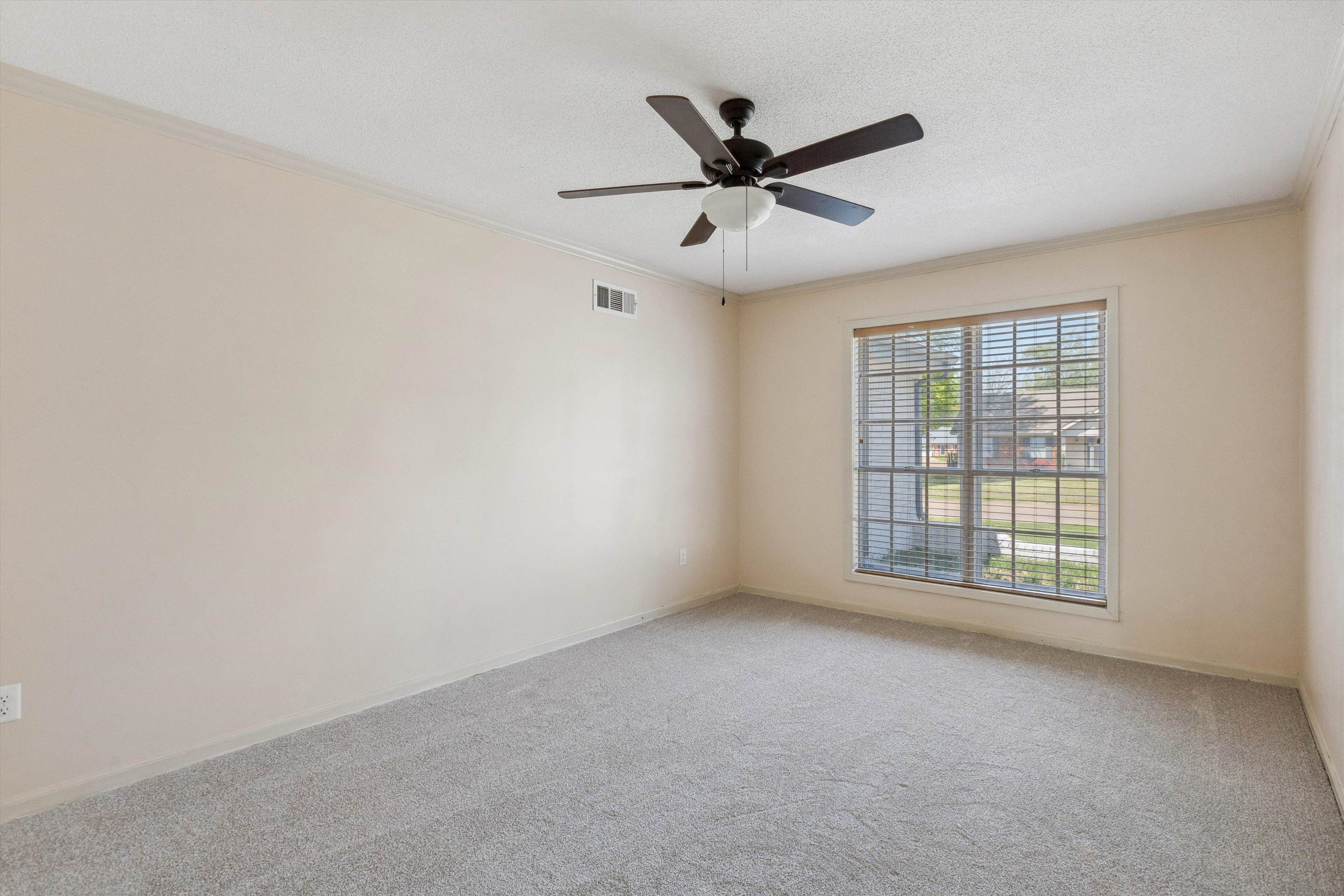 5747 Bartlett Woods Drive Bartlett, TN 38134 - Photo 8 of 28 Spare room featuring crown molding, visible vents, ceiling fan, and carpet floors