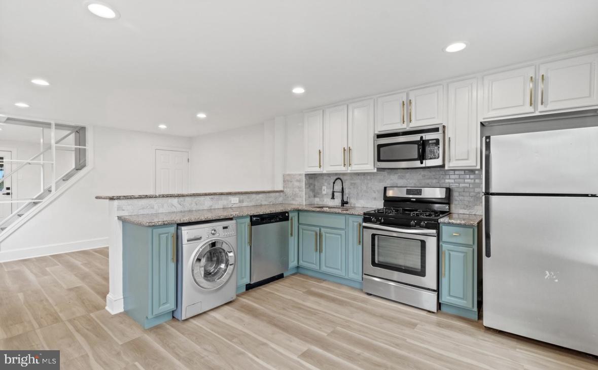 713 Haverford Road Bryn Mawr, PA 19010 - Photo 1 of 12 a kitchen with stainless steel appliances granite countertop a stove a sink and a refrigerator