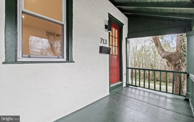 a view of a porch with wooden floor and a window