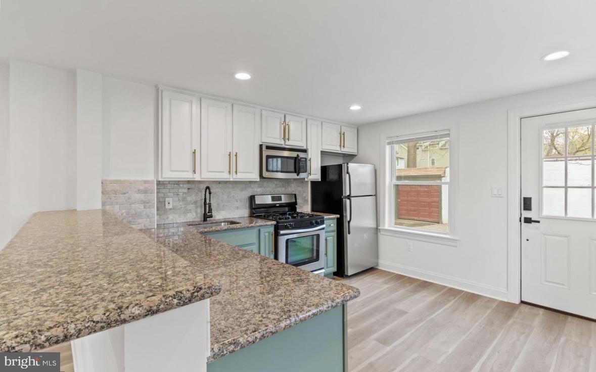 713 Haverford Road Bryn Mawr, PA 19010 - Photo 3 of 12 a kitchen with a stove a sink and a microwave