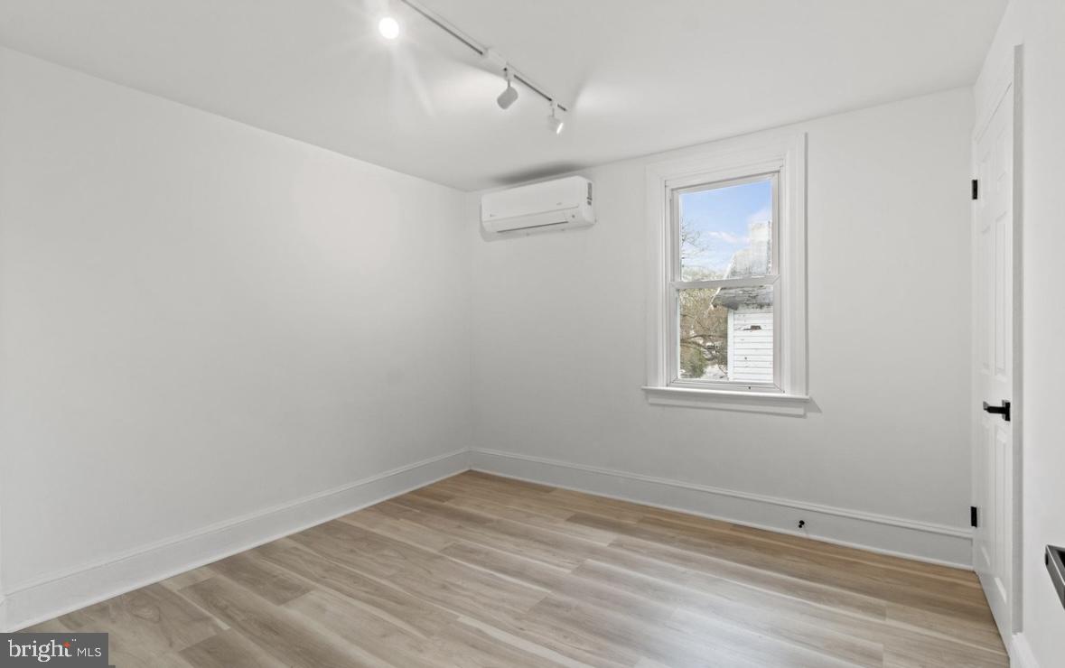 713 Haverford Road Bryn Mawr, PA 19010 - Photo 5 of 12 an empty room with a window and wooden floor
