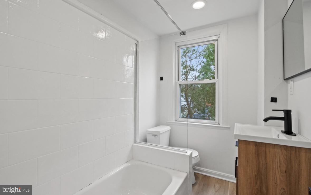 713 Haverford Road Bryn Mawr, PA 19010 - Photo 8 of 12 a bathroom with a bathtub a sink and a window