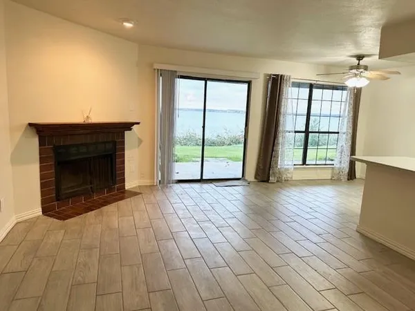 an empty room with wooden floor and fireplace