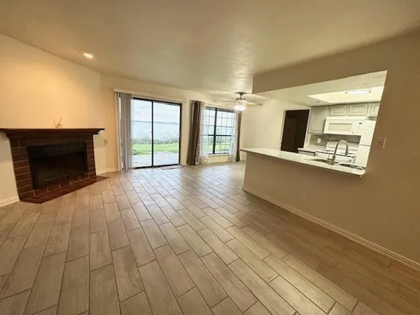 a view of a livingroom with an empty space and a fireplace