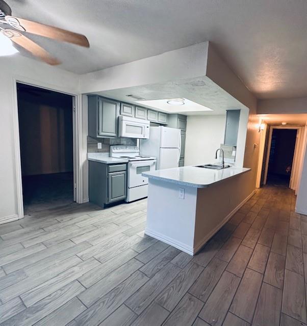 4472 Chaha Road, Unit 104 Garland, TX 75043 - Photo 3 of 7 a large kitchen with stainless steel appliances kitchen island granite countertop a large counter top and wooden floors