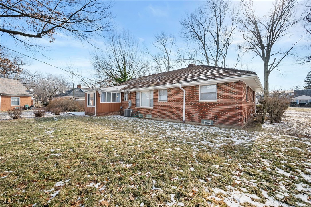 15857 Henley Road Cleveland, OH 44112 - Photo 40 of 42 Snow covered property with central AC unit and a yard