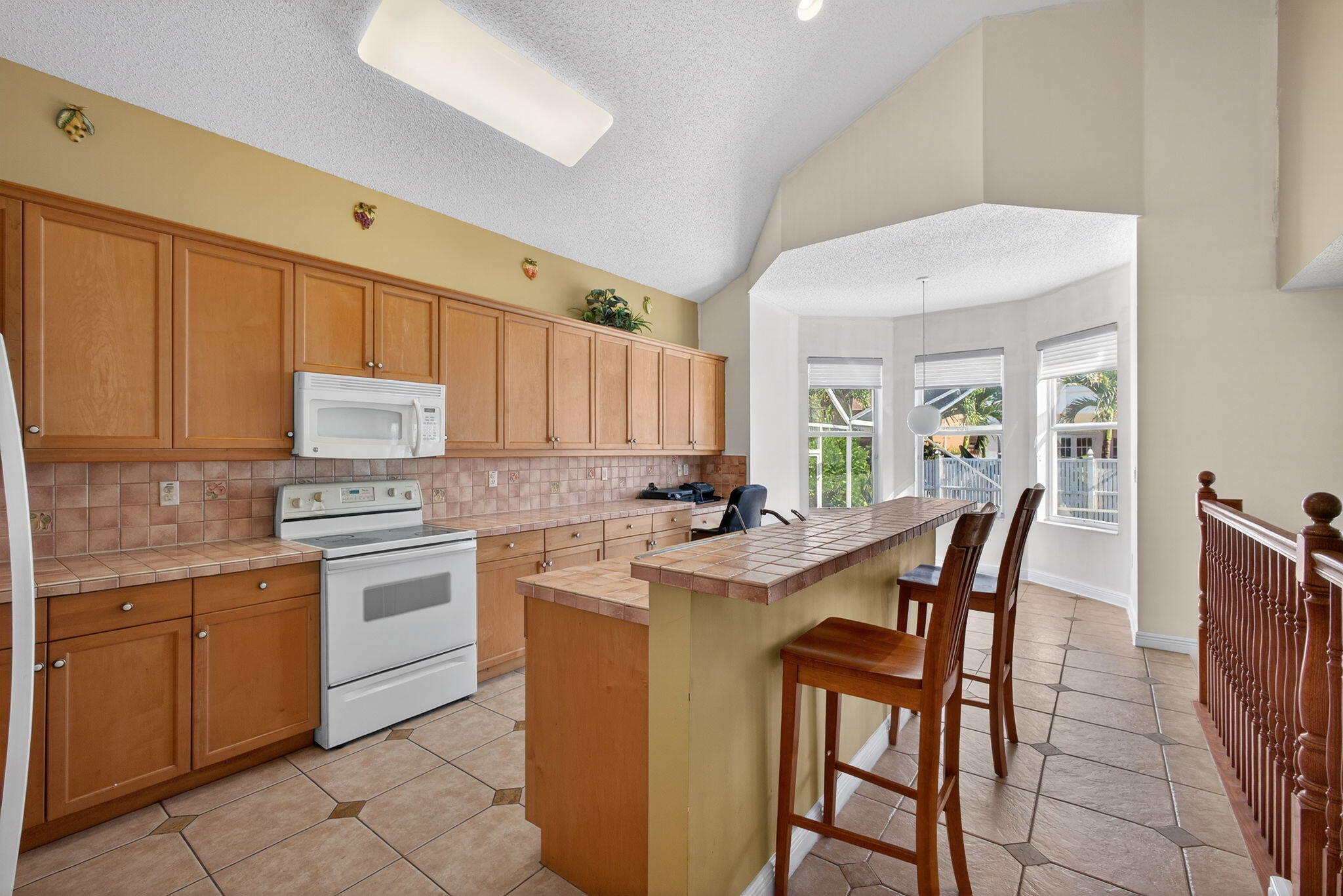 2008 Reston Circle Royal Palm Beach, FL 33411 - Photo 14 of 57 a kitchen with stainless steel appliances granite countertop a table chairs sink and cabinets