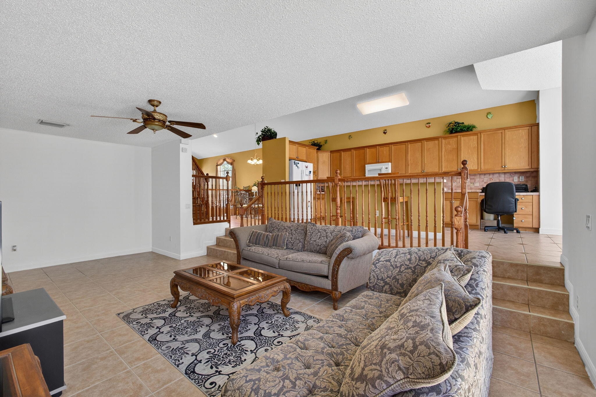 2008 Reston Circle Royal Palm Beach, FL 33411 - Photo 24 of 57 a living room with furniture a rug and a chandelier