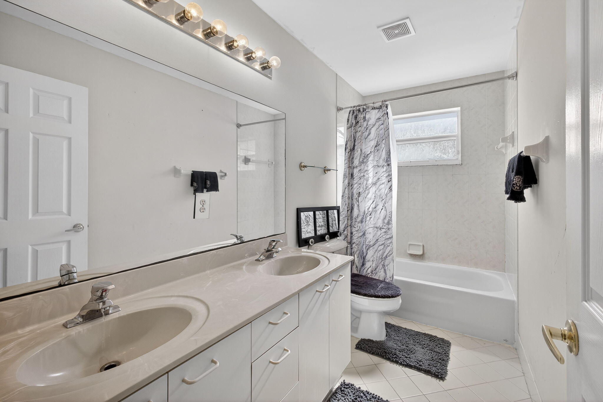 2008 Reston Circle Royal Palm Beach, FL 33411 - Photo 42 of 57 a bathroom with a double vanity sink toilet and shower