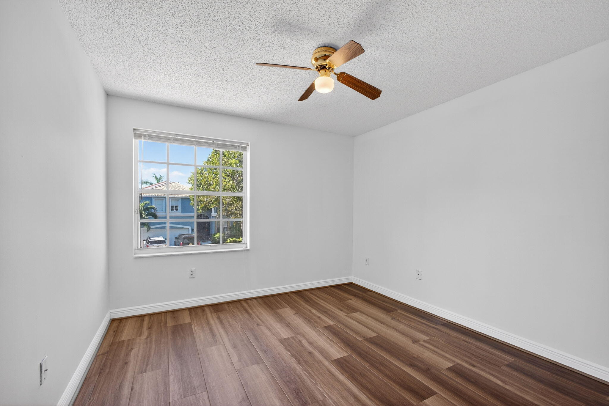 2008 Reston Circle Royal Palm Beach, FL 33411 - Photo 45 of 57 an empty room with a window and wooden floor