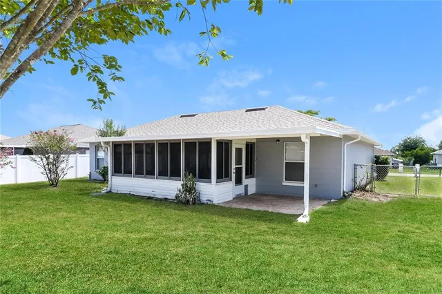 a view of a house with a yard and sitting area