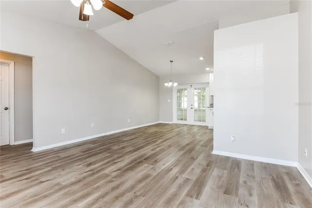 a view of empty room with wooden floor