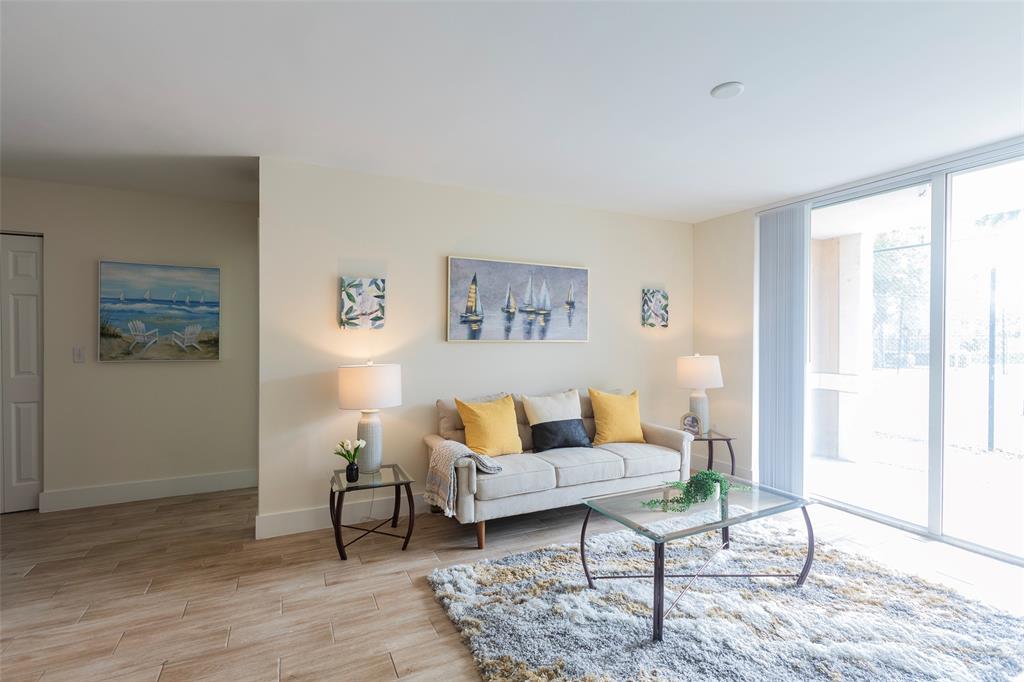 4768 West Atlantic Boulevard, Unit 3204 Coconut Creek, FL 33063 - Photo 11 of 24 a living room with furniture and wooden floor