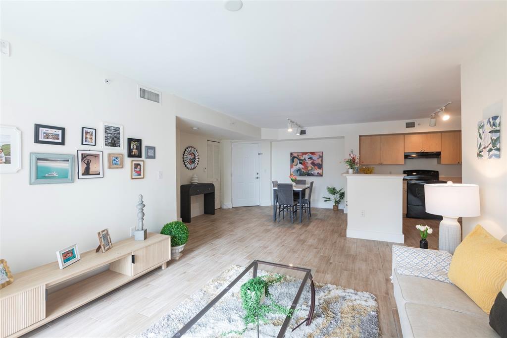 4768 West Atlantic Boulevard, Unit 3204 Coconut Creek, FL 33063 - Photo 12 of 24 a living room with furniture and a fireplace