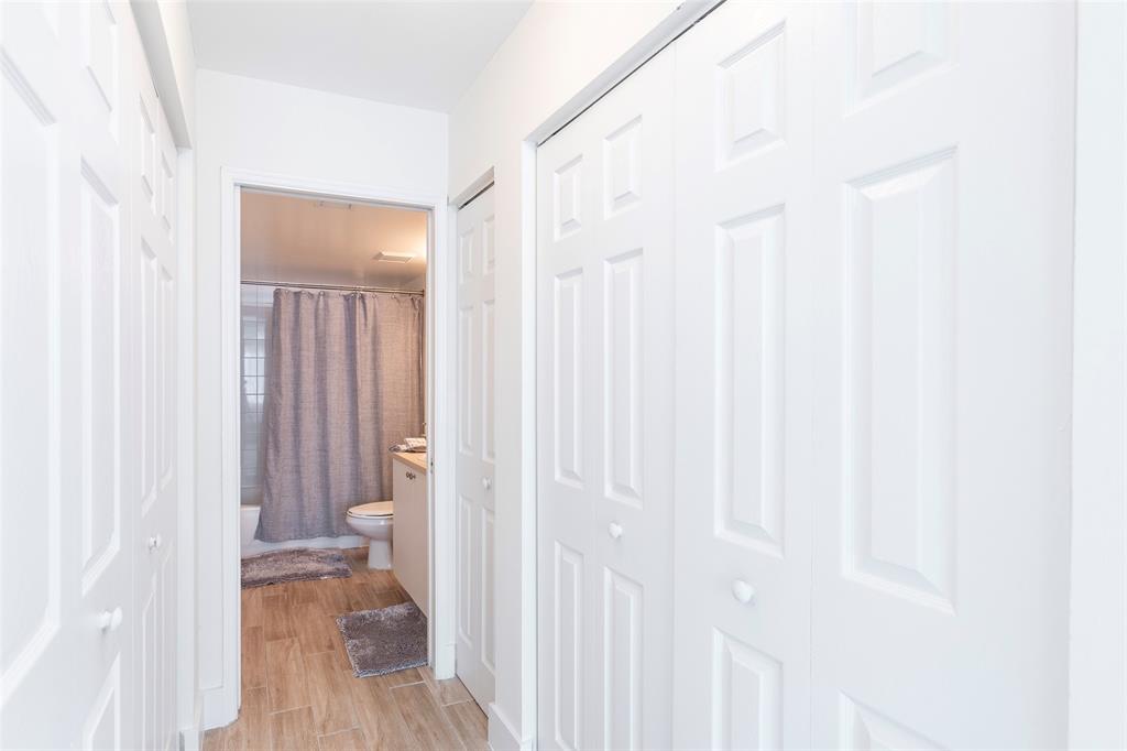 4768 West Atlantic Boulevard, Unit 3204 Coconut Creek, FL 33063 - Photo 2 of 24 a view of a hallway with wooden floor and a bathroom