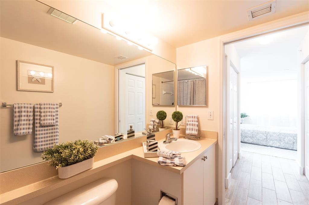 4768 West Atlantic Boulevard, Unit 3204 Coconut Creek, FL 33063 - Photo 3 of 24 a bathroom with a sink and mirror with bathtub