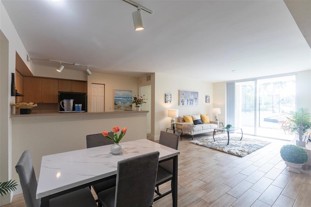 4768 West Atlantic Boulevard, Unit 3204 Coconut Creek, FL 33063 - Photo 9 of 24 a view of a dining room with furniture and a livingroom