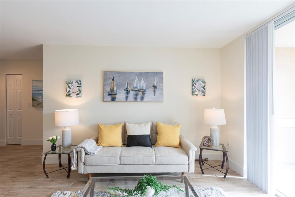 4768 West Atlantic Boulevard, Unit 3204 Coconut Creek, FL 33063 - Photo 10 of 24 a living room with furniture and a lamp