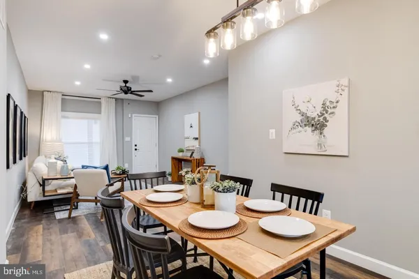 a view of a dining room with furniture and wooden floor