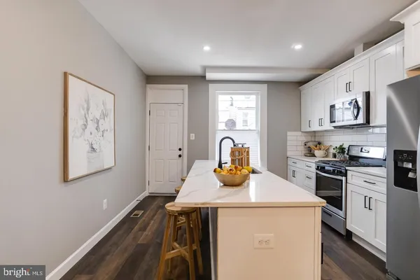 a kitchen with a sink a stove and cabinets