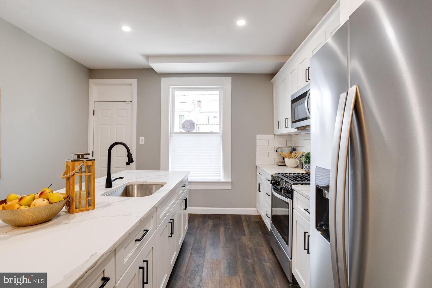 3011 Pulaski Highway Baltimore, MD 21224 - Photo 19 of 55 a kitchen with sink a refrigerator and cabinets