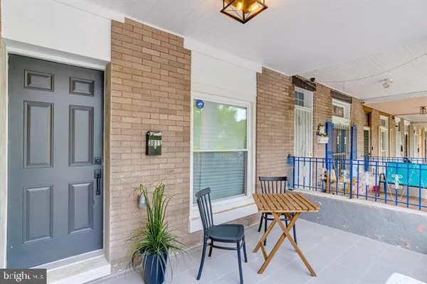 a balcony with table and chairs
