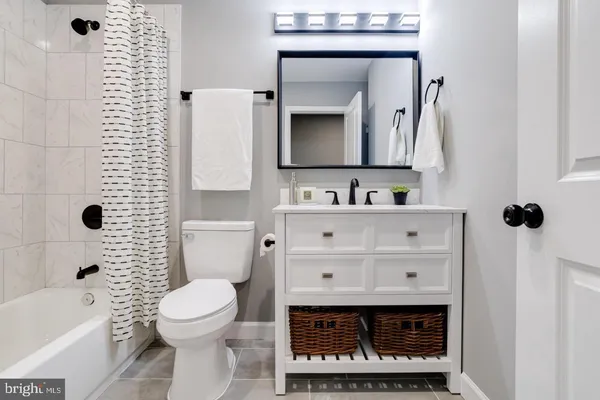 a bathroom with a sink a toilet and a mirror