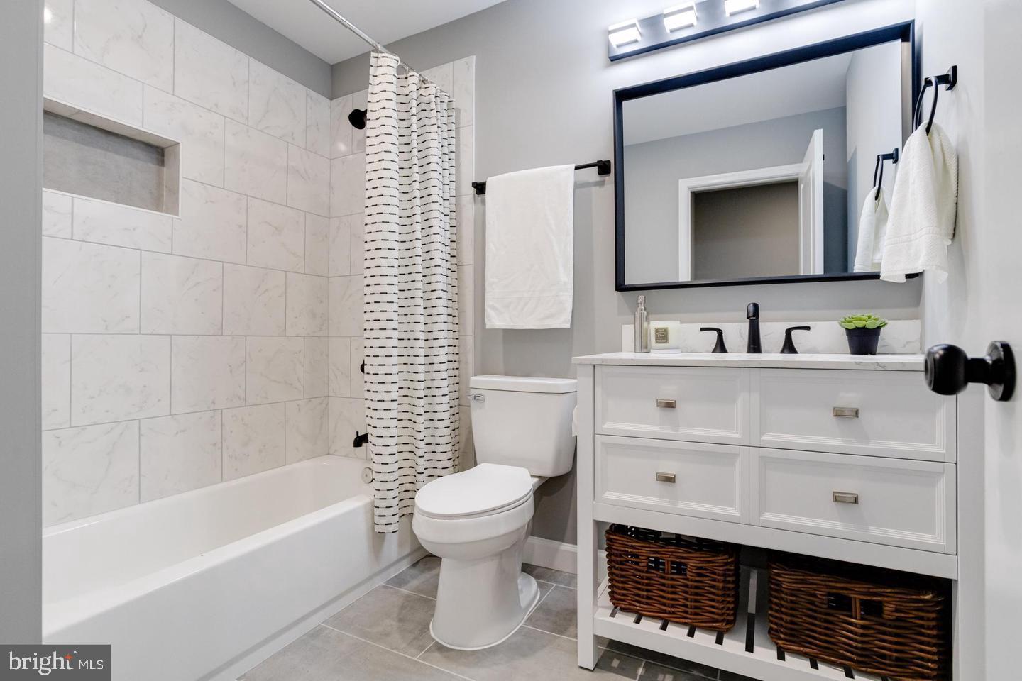 3011 Pulaski Highway Baltimore, MD 21224 - Photo 29 of 55 a bathroom with a sink a toilet and a mirror