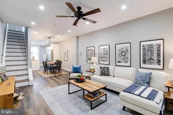 a living room with furniture and wooden floor