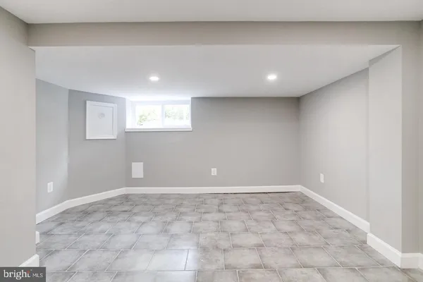 a bathroom with a tub a sink and mirror