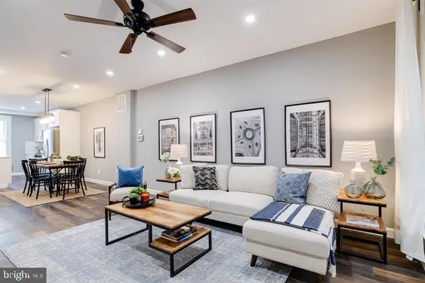 a living room with furniture and a ceiling fan