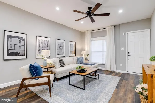 a living room with furniture and a wooden floor