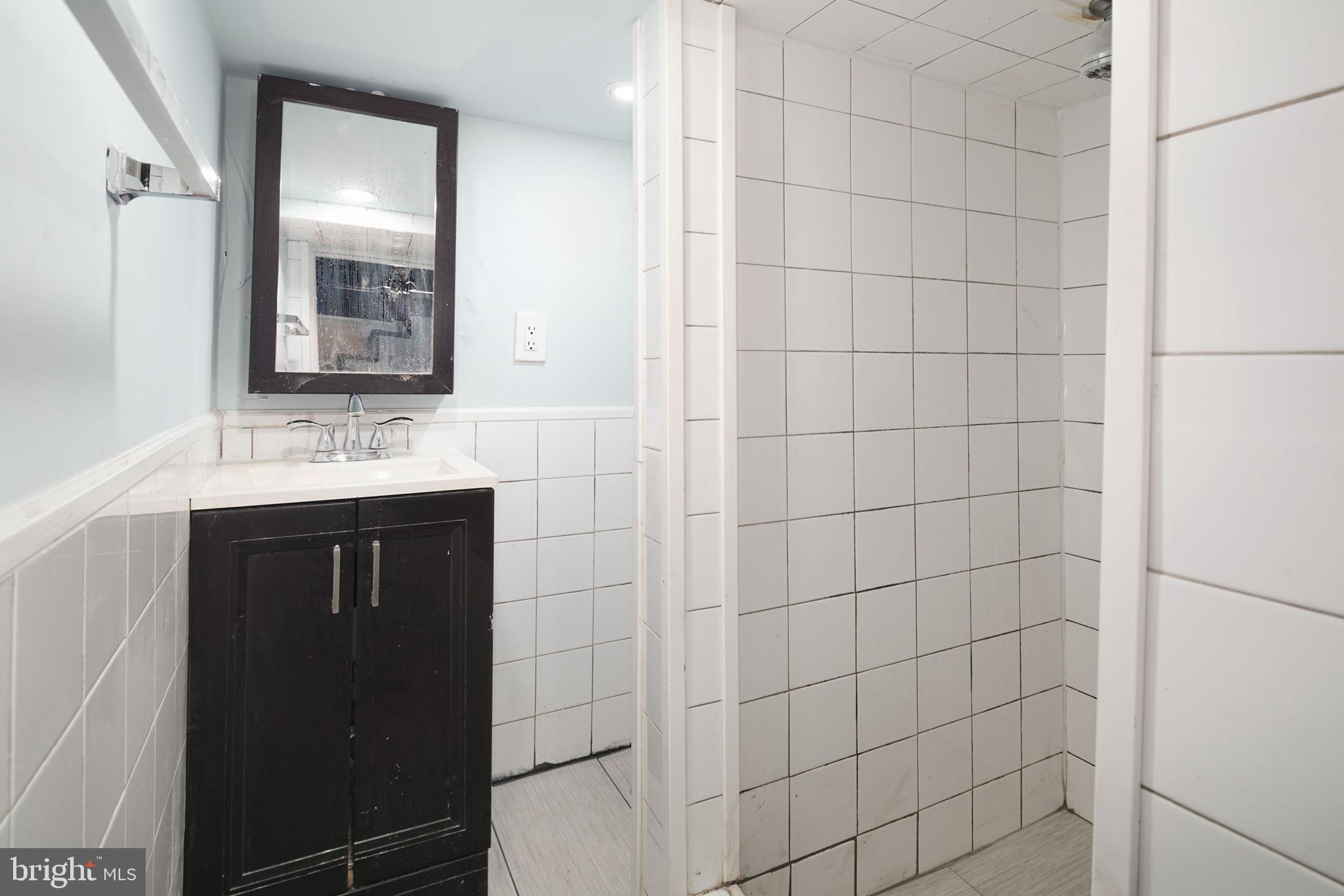 1735 Mifflin Street Philadelphia, PA 19145 - Photo 15 of 16 a bathroom with a sink and a mirror