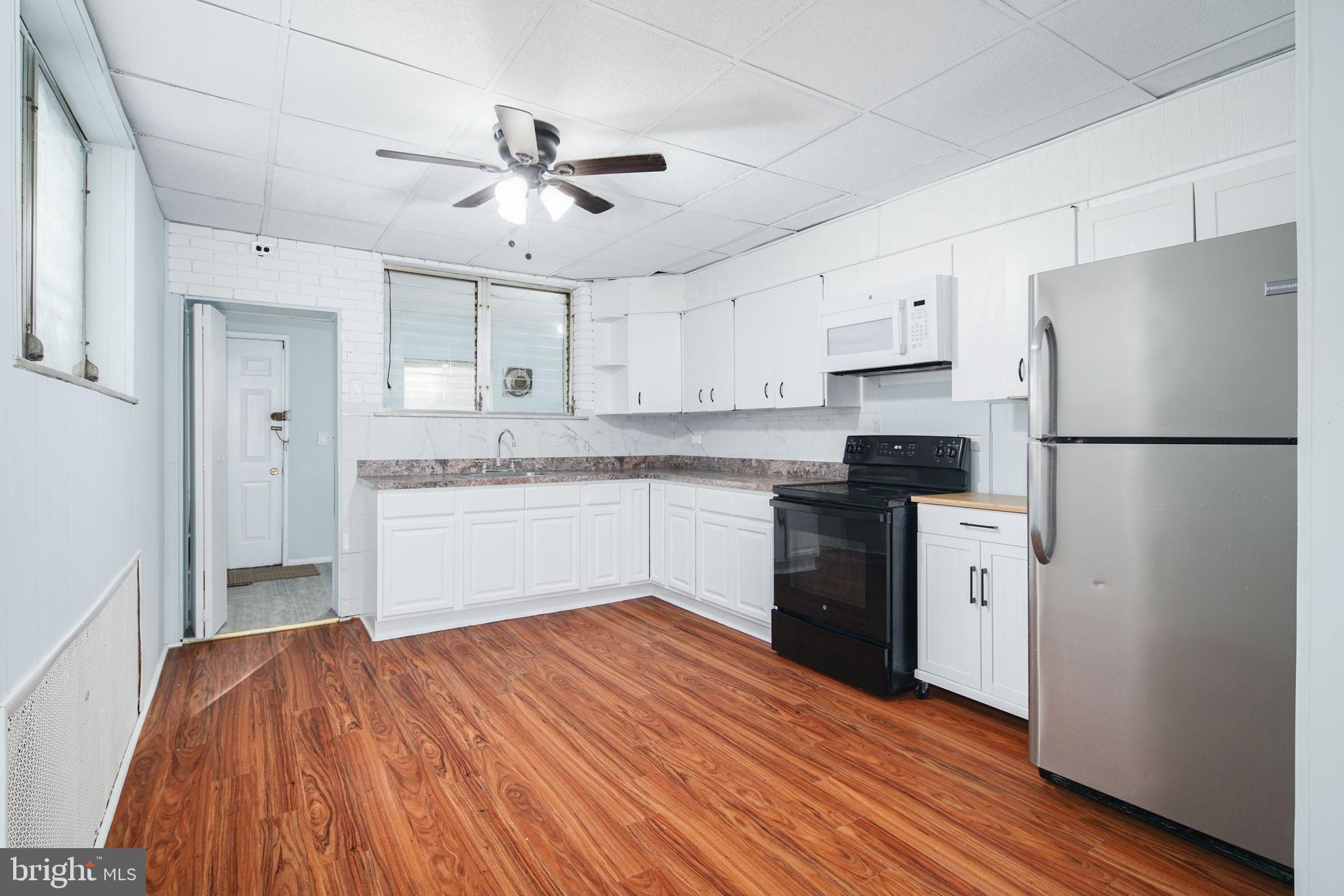 1735 Mifflin Street Philadelphia, PA 19145 - Photo 5 of 16 a kitchen with a refrigerator a sink and dishwasher