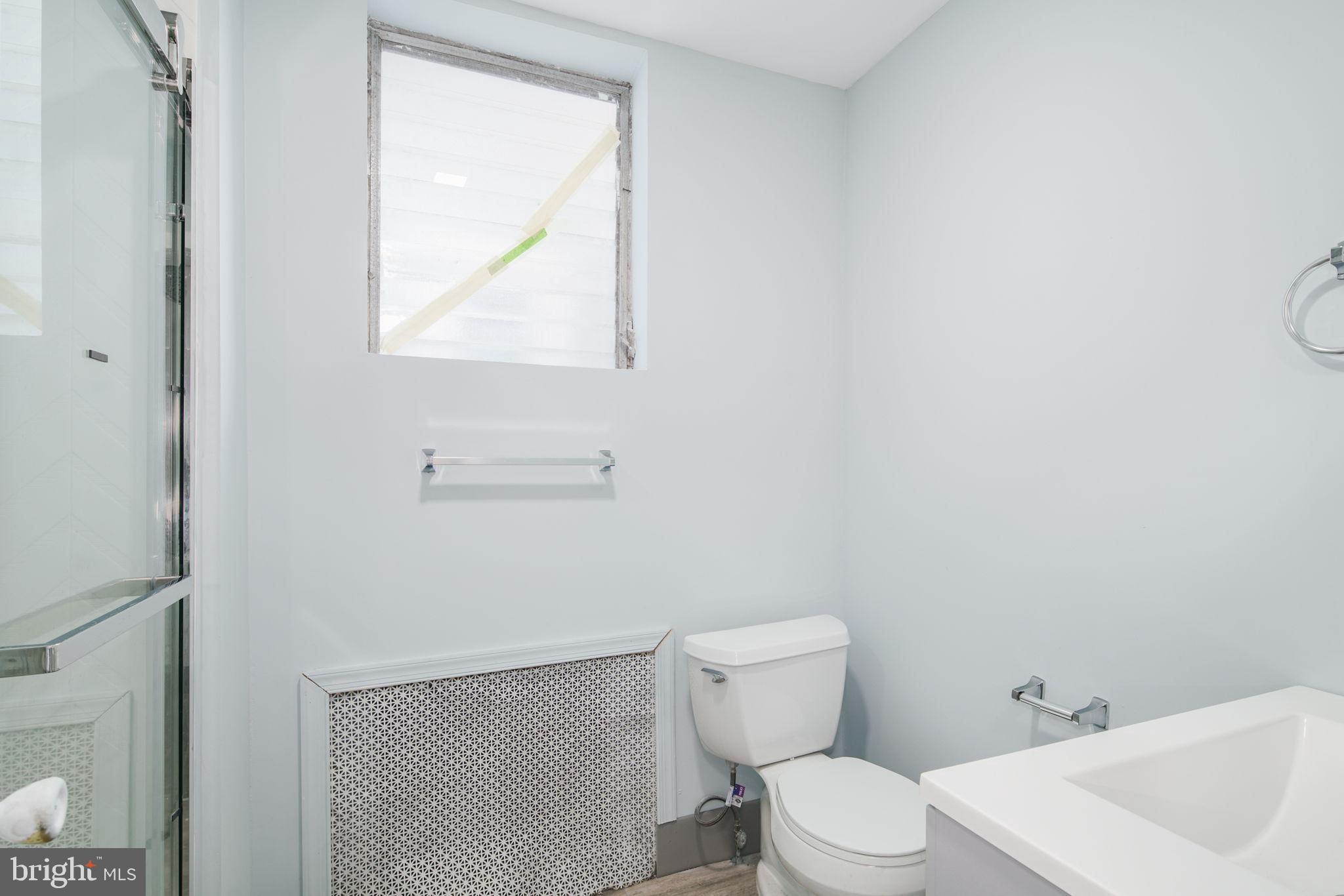 1735 Mifflin Street Philadelphia, PA 19145 - Photo 9 of 16 a white toilet sitting next to a bathroom sink