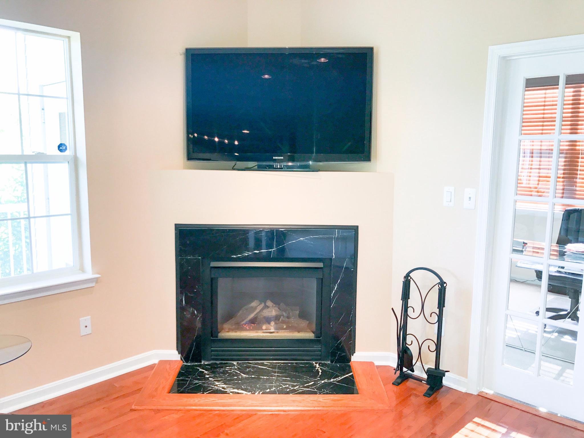 41 Hawk Rise Lane, Unit 202 Owings Mills, MD 21117 - Photo 12 of 33 a living room with fireplace and a wooden floor