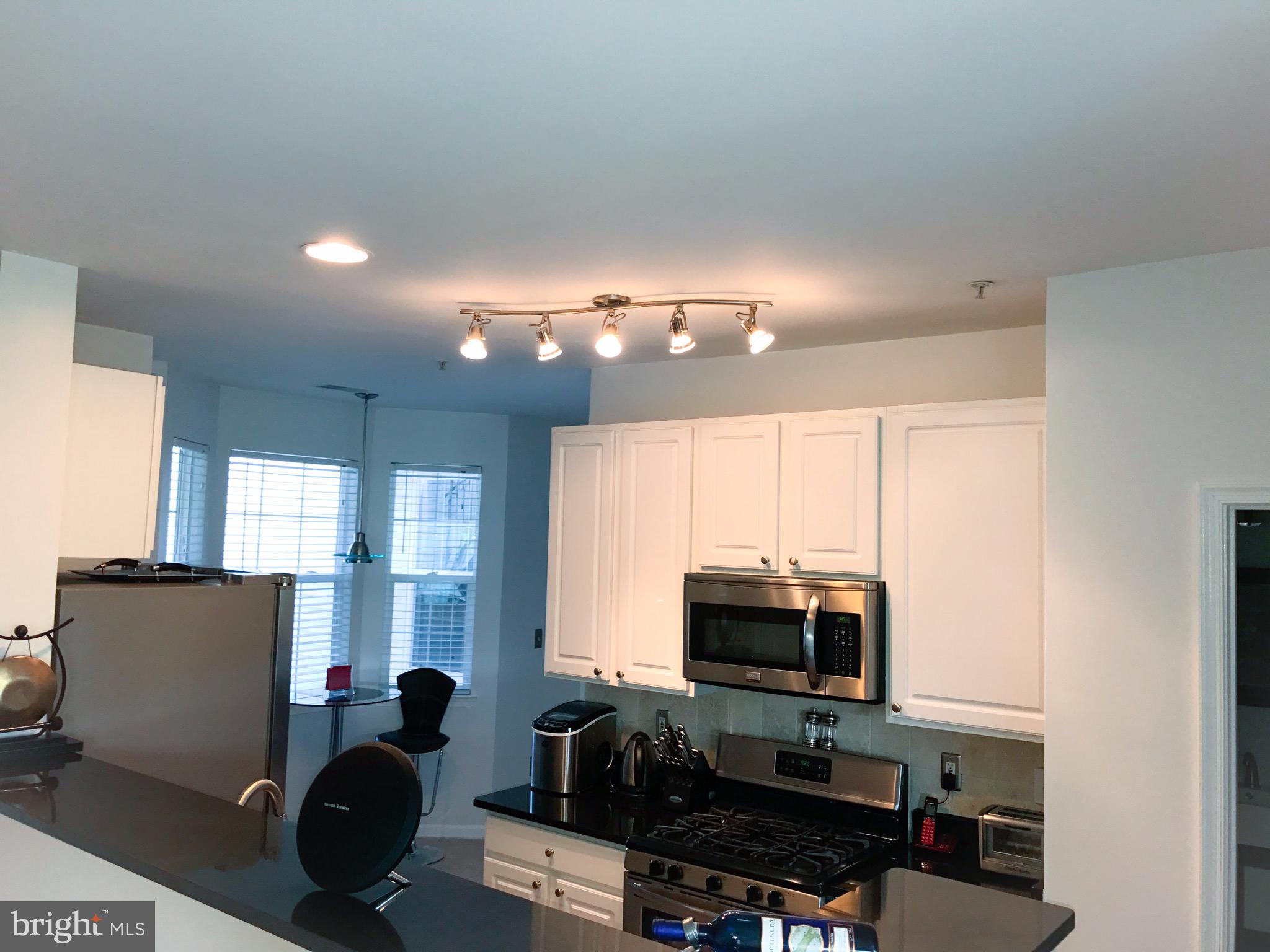 41 Hawk Rise Lane, Unit 202 Owings Mills, MD 21117 - Photo 3 of 33 a kitchen with stainless steel appliances a refrigerator and a stove top oven