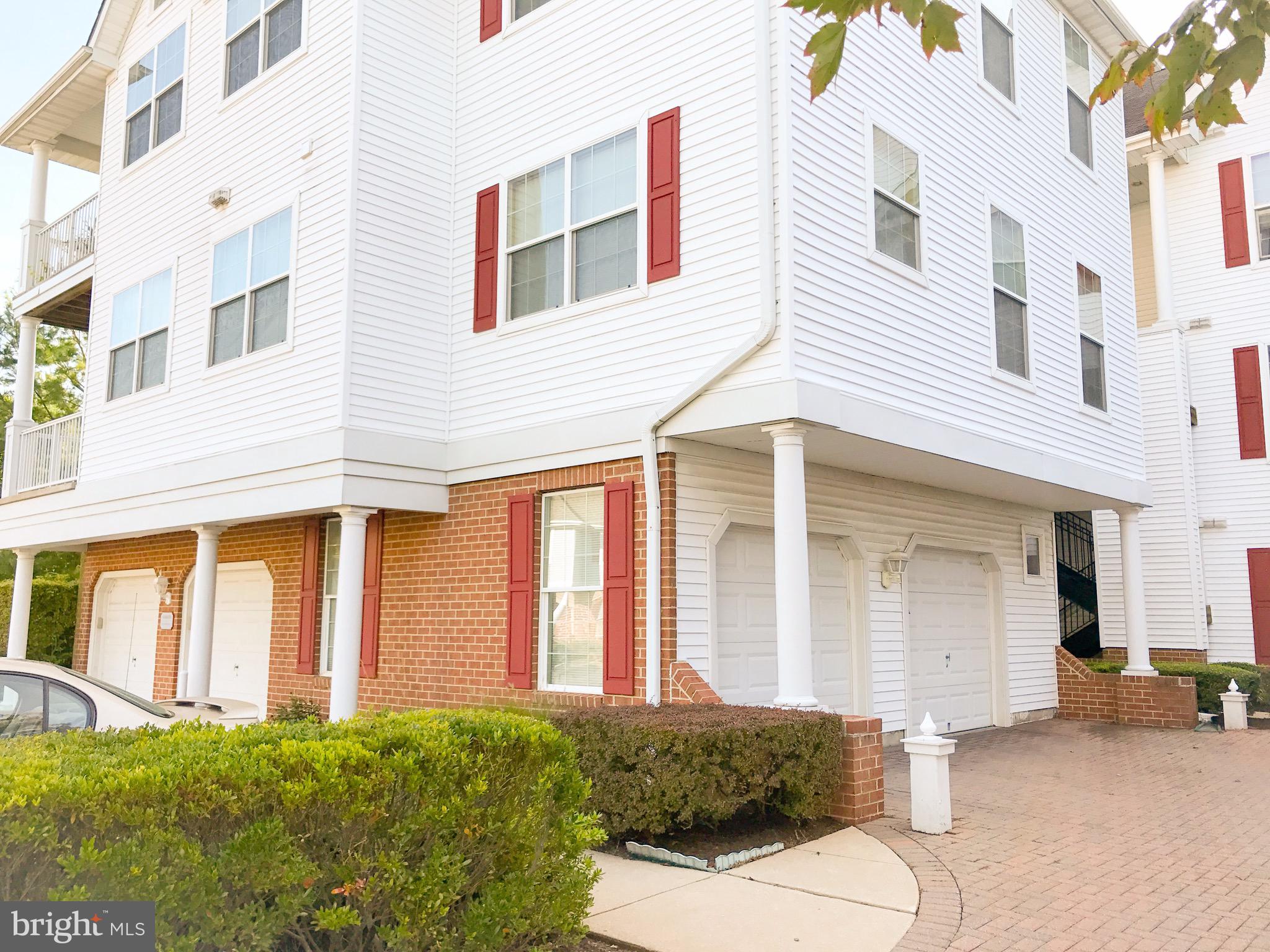 41 Hawk Rise Lane, Unit 202 Owings Mills, MD 21117 - Photo 32 of 33 a view of a white house with large windows
