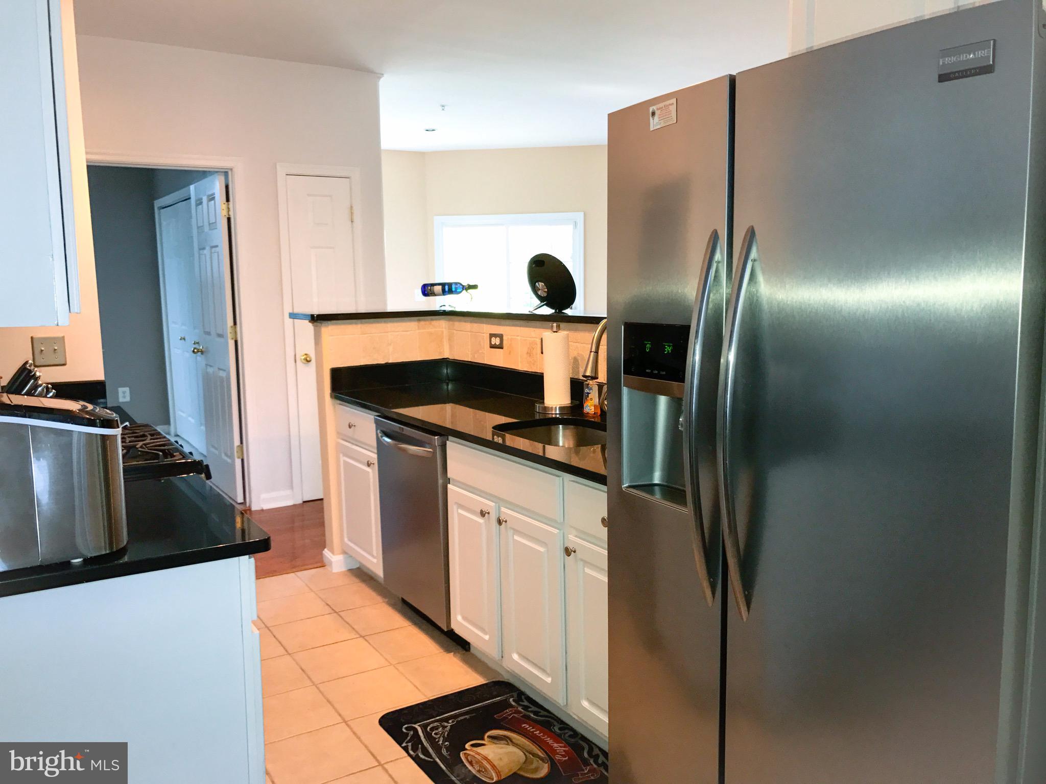 41 Hawk Rise Lane, Unit 202 Owings Mills, MD 21117 - Photo 5 of 33 a kitchen with stainless steel appliances granite countertop a refrigerator and a stove