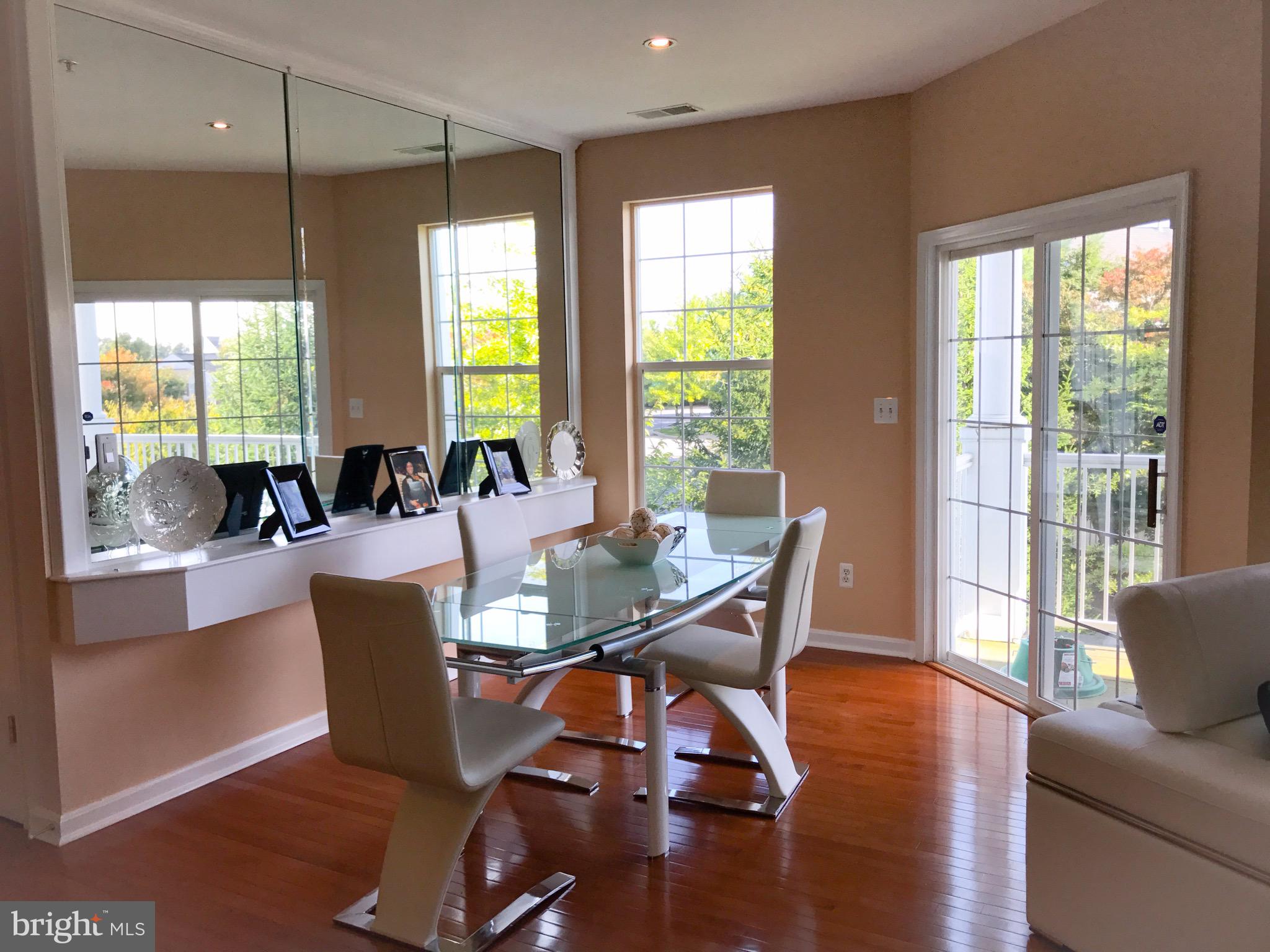 41 Hawk Rise Lane, Unit 202 Owings Mills, MD 21117 - Photo 8 of 33 a view of a dining room with furniture window and wooden floor