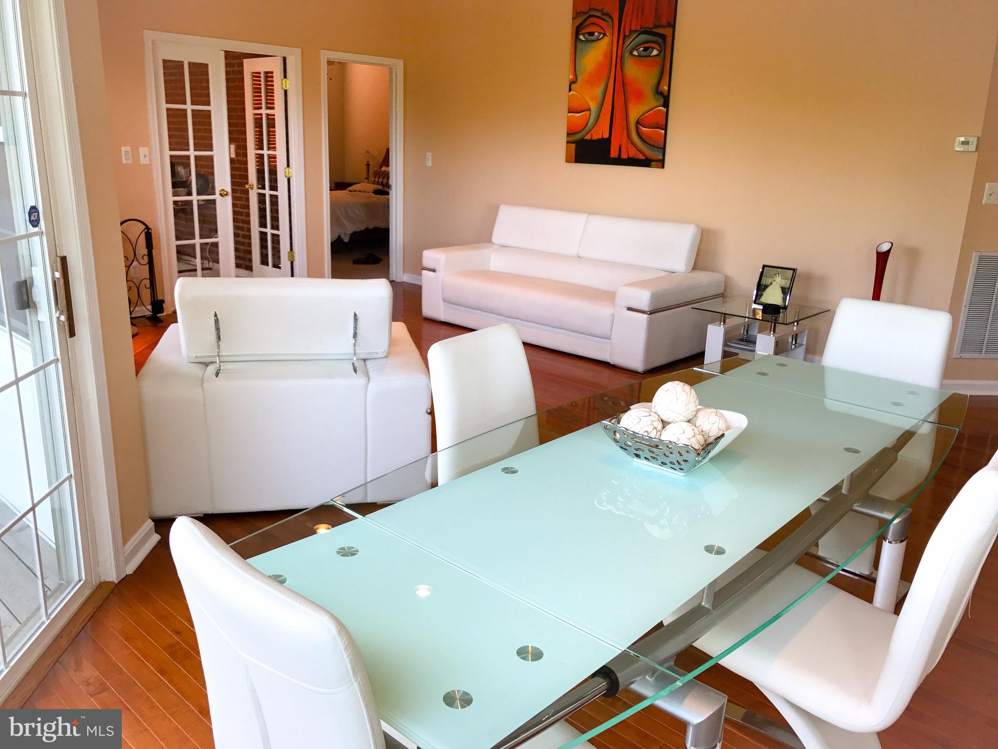 41 Hawk Rise Lane, Unit 202 Owings Mills, MD 21117 - Photo 9 of 33 a living room with furniture and large window